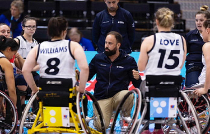 Laurie Williams and Robyn Love listening to coach instructions on the court