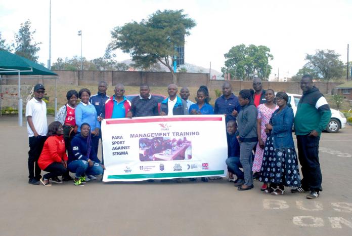 a group of people holding up a Para sport training sign 