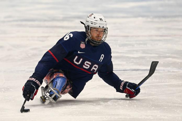 A male Para ice hockey player competes.