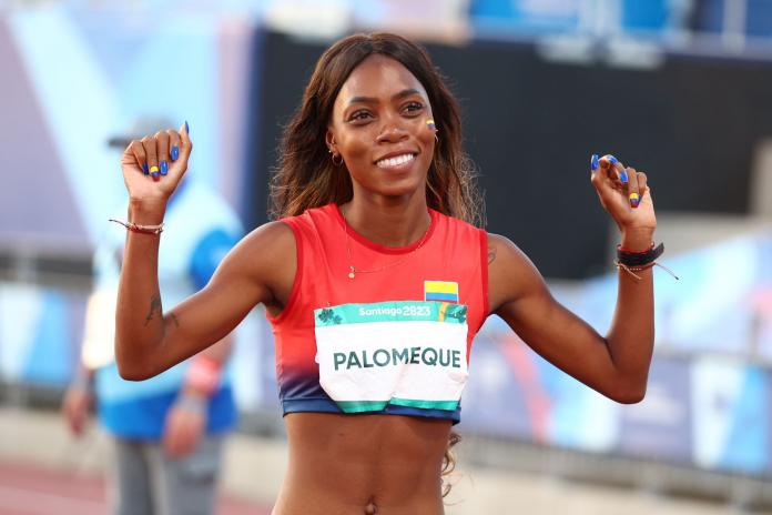 A female athlete from Colombia celebrates after a win by pumping her fists