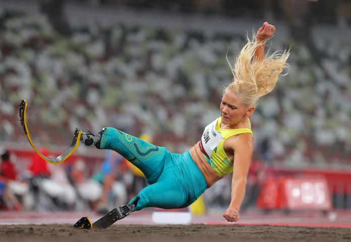A female athlete competes in the long jump.