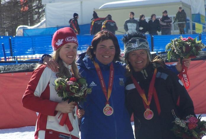 Three female skiers pose for a photo with their medals 