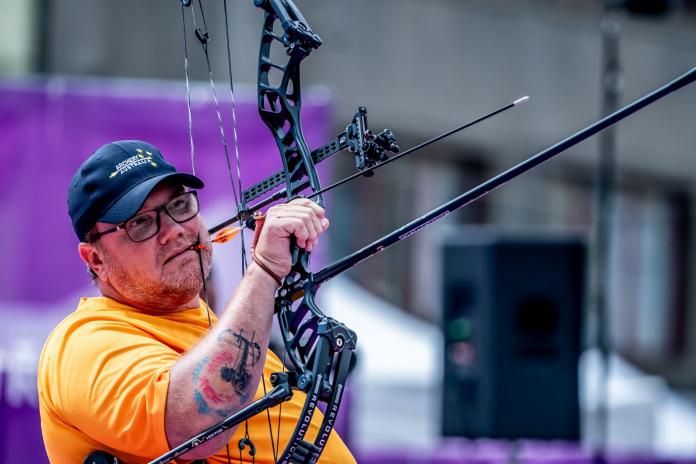 A male Para archer holds his bow with his right hand.