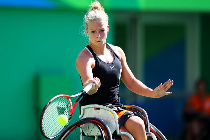 A female wheelchair tennis player in action