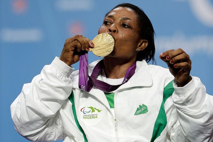 A female athlete kisses a gold medal