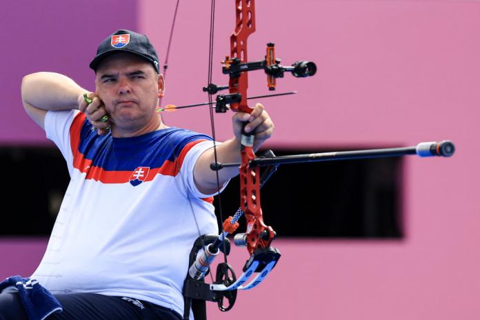 A male archer positions his bow