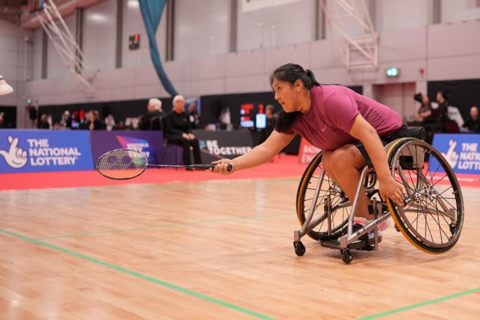A female Para badminton player, who competes in a wheelchair, in action
