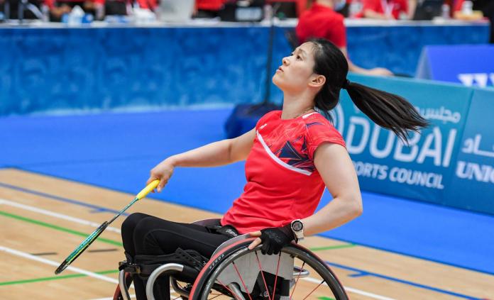 A female Para badminton player, who plays in a wheelchair, in action during a match