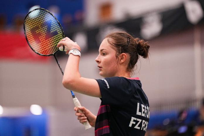 A close up shot of a female Para badminton player preparing to serve