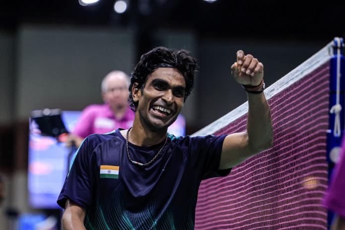 A male Para badminton player pumps his left fist after a match at the 2024 World Championships.