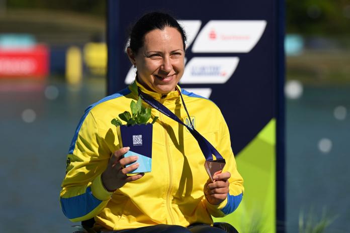 Maryna Mazhula, a Para canoe athlete from Ukraine, poses for a photo with a medal