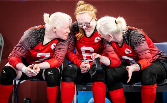 Three female goalball players speaking