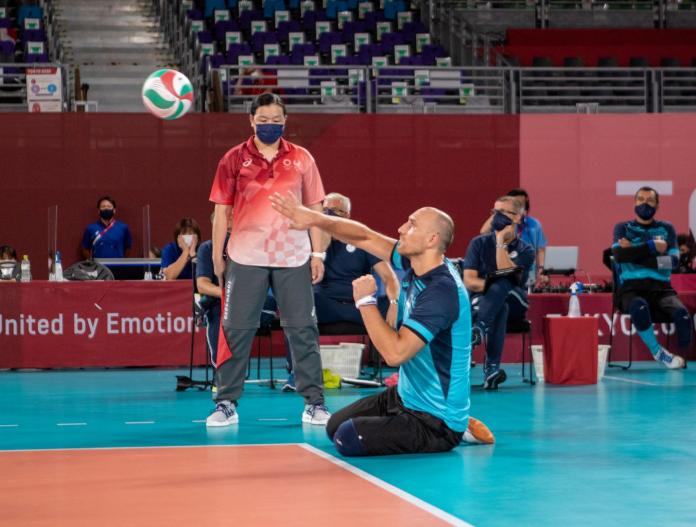 Male sitting volleyball players in competition