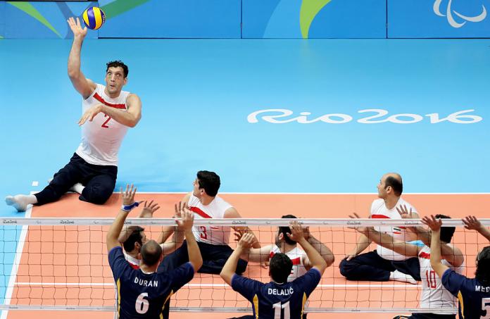 Two men's sitting volleyball teams in competition