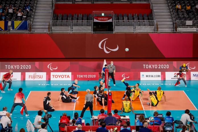 Two men's sitting volleyball teams in competition