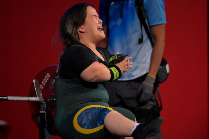 A female Para powerlifter reacts after a lift.