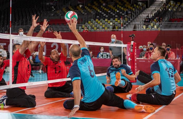 Male sitting volleyball players in competition