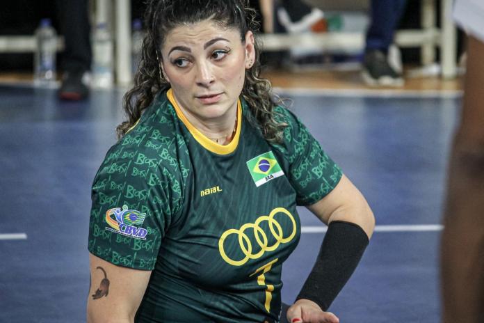 A close up shot of a female sitting volleyball player on court