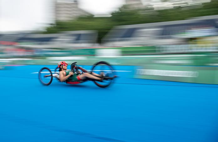 A female Para triathlete competes in a handcycle