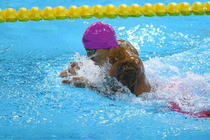 A male Para swimmer competes 