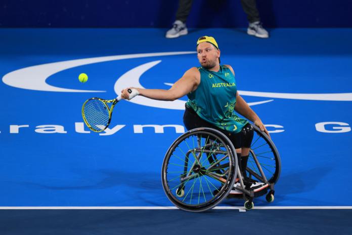 A male wheelchair tennis player competes