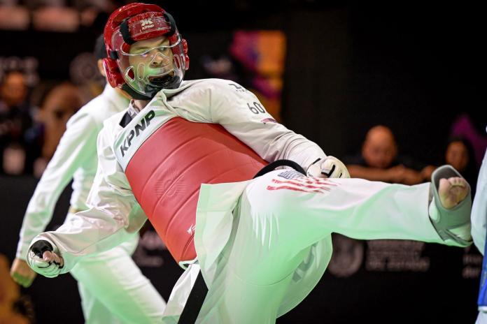 A male Para taekwondo athlete kicking