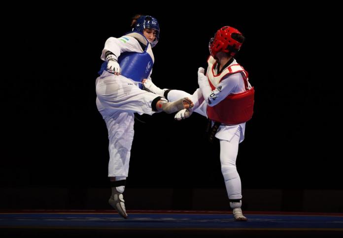 Two Para taekwondo athletes in action. 