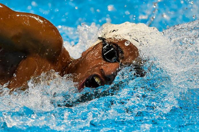 A male Para swimmer competing