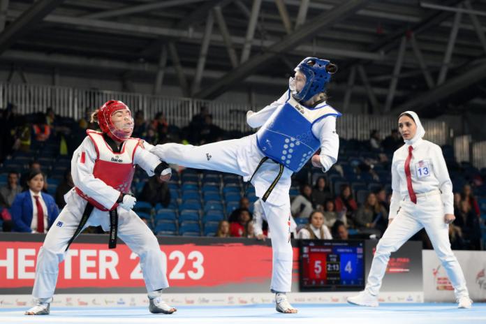 Two female Para taekwondo athletes in action