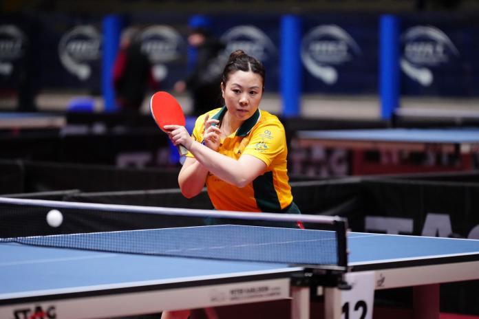A female Para table tennis player in action.