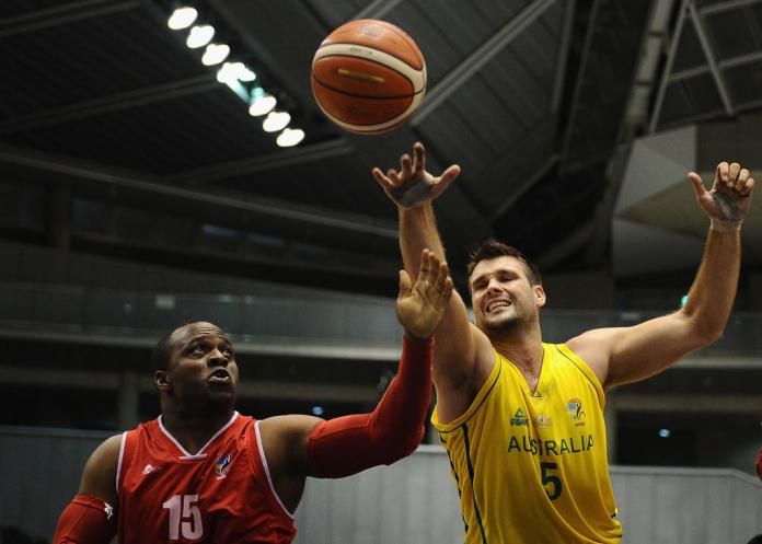 Two male wheelchair basketball players competes for the rebound