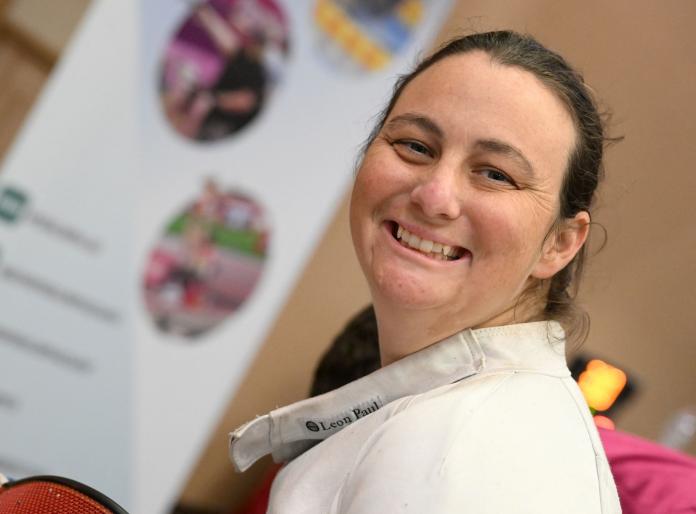 A female Para athlete smiling at the camera