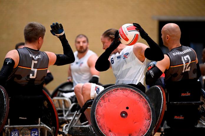 Sarah Adam carries the ball during a wheelchair rugby match