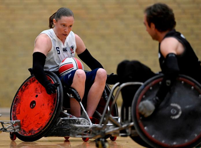 Sarah Adam carries the ball during a wheelchair rugby match