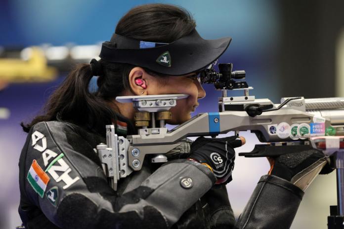 A female shooting Para sport athlete aims