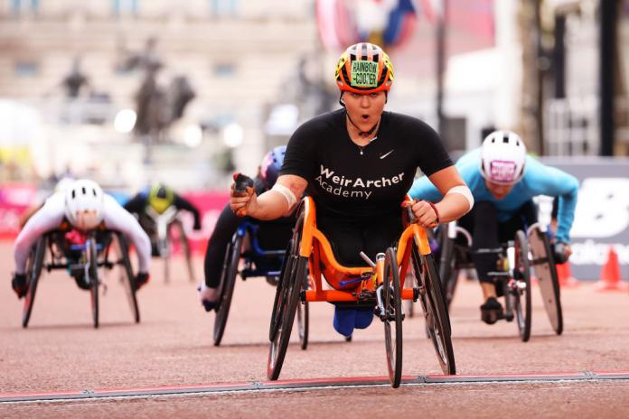 Wheelchair racer Eden Rainbow-Cooper celebrates crossing the finish line