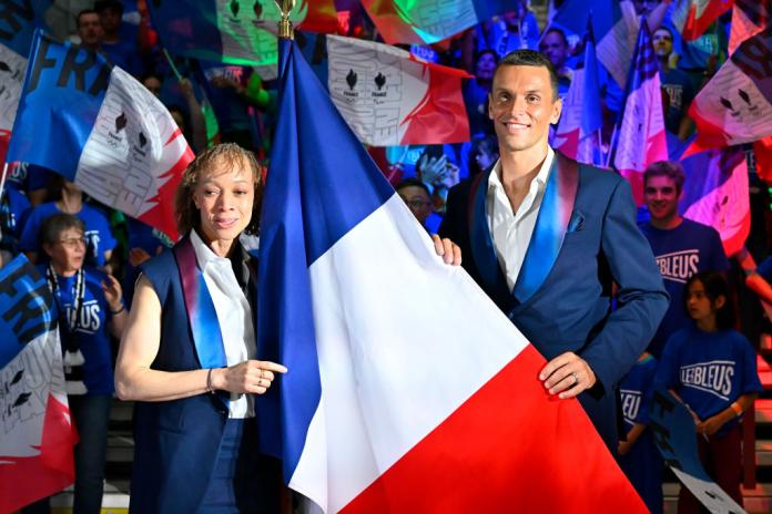 Para athletes Alexis Hanquinquant and Nantenin Keita hold the French flag in front 