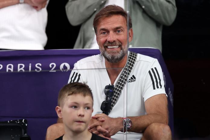 The former Liverpool manager Jurgen Klopp wearing a white t-shirt watches Para badminton from the stands