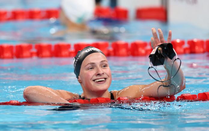 Chantelle Zijderveld waves while in the pool at the end of a race