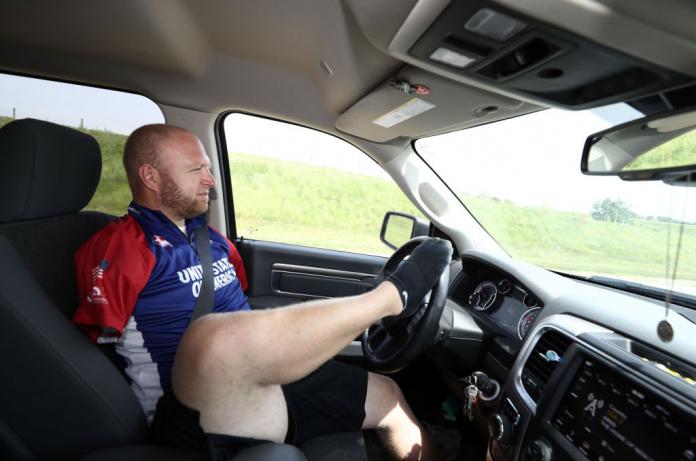 Matt Stutzman, the US "Armless Archer", is driving a car. He steers with his right foot