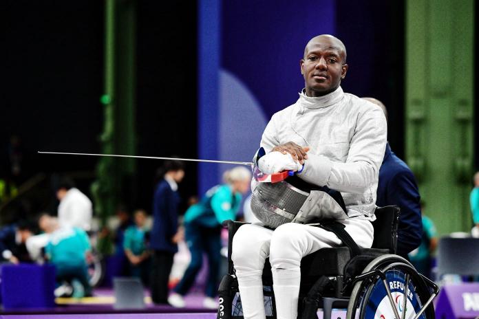 Amelio Castro waits with his helmet and sabre