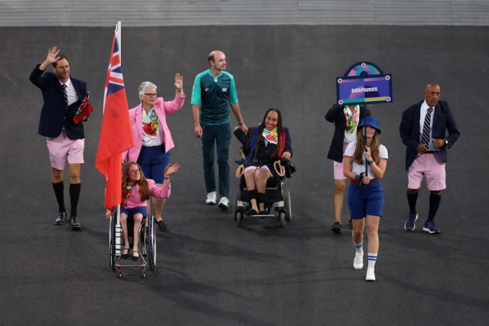 Two female athletes and officials takke part in the Paris 2024 Parade of Nations