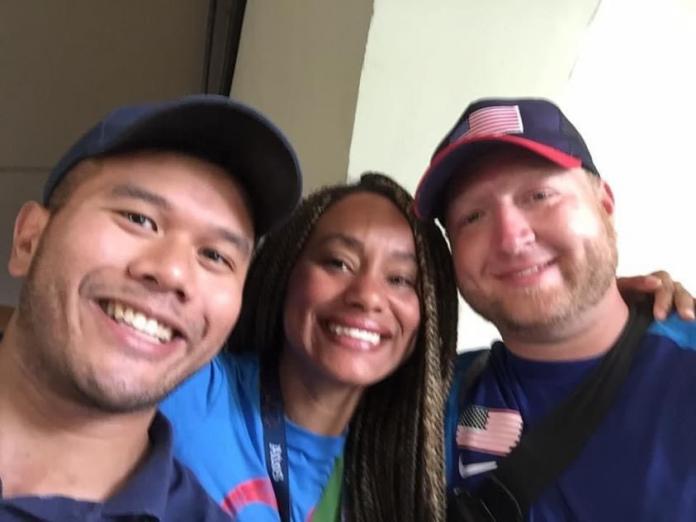 Man, woman, man face camera smiling