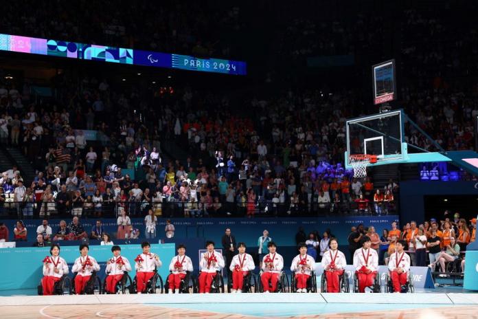A line of Chinese wheelchair basketballers on the podium 