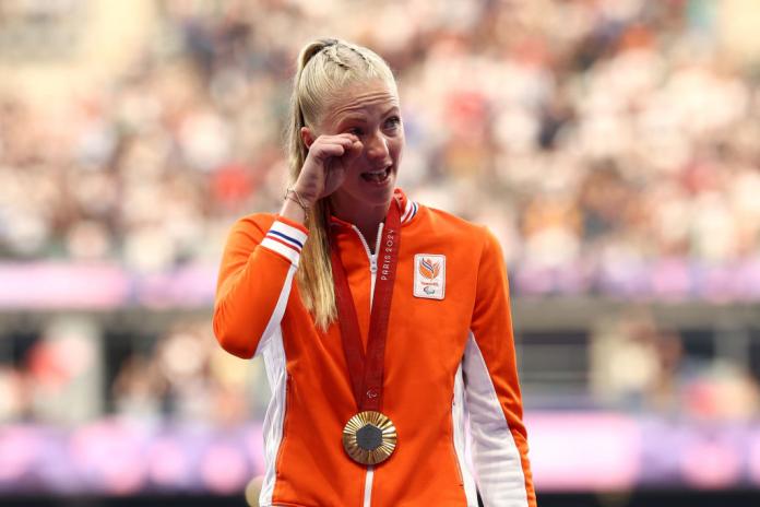 Para athlete Fleur Jong wipes away a tear on the podium 