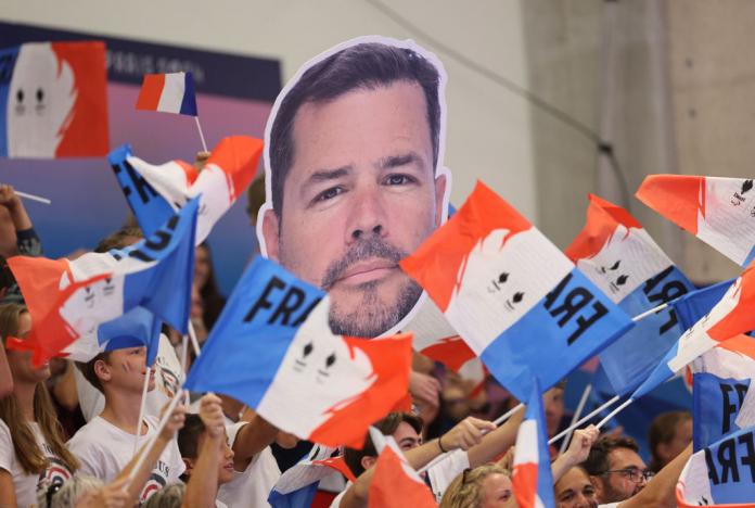 A group of French fans with flags in the stands