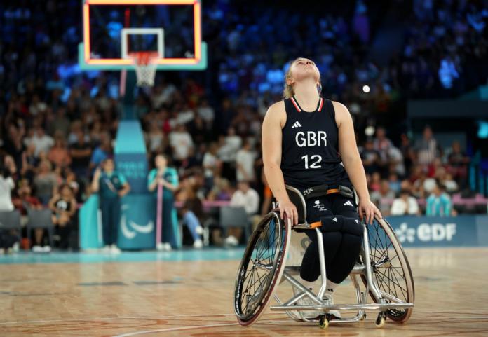 A female British wheelchair basketballer looks up at the sky in despair 