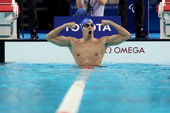 Para swimmer Simone Barlaam roars in celebration in the pool