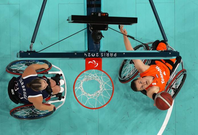 a wheelchair basketball player lines up a shot