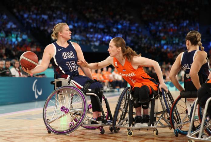 two female wheelchair basketballers fight for the ball